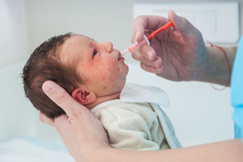 Infant Receiving Vitamin D Supplement via oral syringe